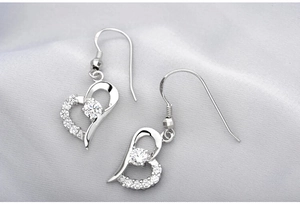 Macro detail of S925 sterling silver heart earrings with sparkling cubic zirconia