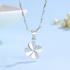 Macro shot of polished S925 silver four-leaf clover pendant with fine chain link detail