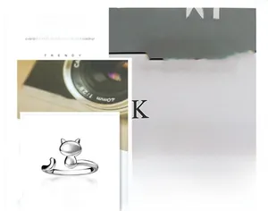 Detail of silver cat-shaped open ring with adjustable minimalist metal band
