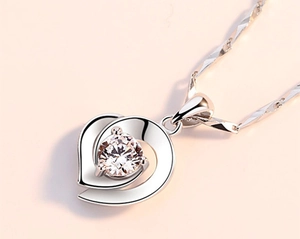 Macro detail of S925 sterling silver heart necklace with a sparkling cubic zirconia stone
