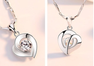 Macro detail of S925 sterling silver double heart necklace with a brilliant round diamond