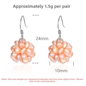 Detail view of woven pink irregular freshwater pearl cluster drop earrings with silver hooks