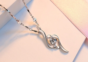 Macro shot of s925 silver necklace with a heart-shaped zircon pendant on a white background