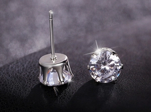 Detailed macro view of S925 sterling silver earrings with six-prong crown setting