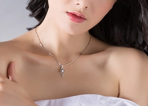 Close-up of minimalist S925 sterling silver wavy pendant necklace with round diamond inlay