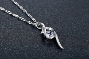 Macro shot of S925 sterling silver ribbon pendant with round brilliant-cut zircon