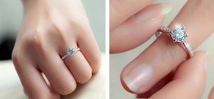Macro view showing a classic 6-prong silver ring with a sparkling 1-carat moissanite stone