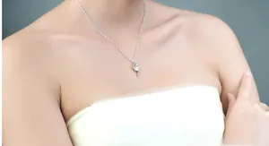 Close-up of S925 sterling silver necklace featuring a sleek pendant with a round white stone