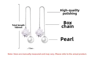 Detail view of long drop earrings featuring a 10mm shell pearl and star-cut crystal detail