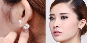 Close-up of S925 silver double-sided stud earrings with shimmering pave crystal spheres