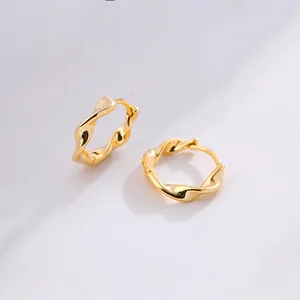 Detailed close-up of S925 sterling silver Mobius hoop earrings with a polished gold finish