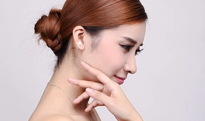 Close-up of model wearing S925 sterling silver stud earrings and fine necklace set