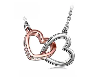 Macro shot of double heart pendant with rose gold finish and sparkling zircon stones