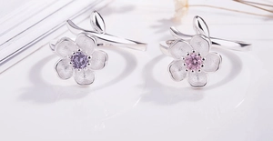 Detail of S925 silver cherry blossom rings with purple zircon and matte petal finish