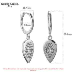 Macro shot of S925 sterling silver teardrop earring showing engraved geometric patterns