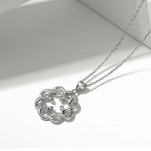 Macro view of S925 sterling silver concentric knot pendant with elegant shadow detail
