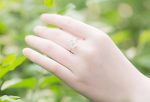 Close-up of S925 silver cherry blossom ring with pink stone on model hand