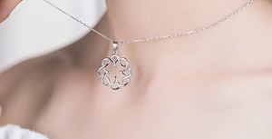 Close-up of S925 sterling silver bow knot pendant on minimalist link chain for women