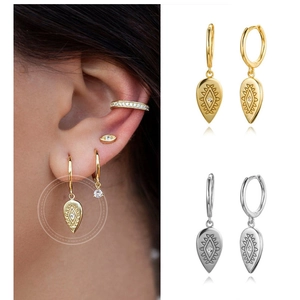 Detail of S925 sterling silver teardrop earrings with totem engraving and crystals
