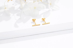 Detailed macro view of gold-plated 925 sterling silver bar studs with S925 butterfly back