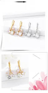 Detail view of sparkling crystal cherry earrings with gold and silver plated settings