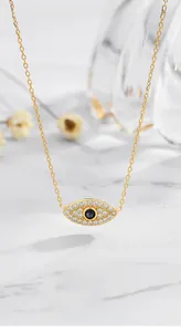 Detailed view of S925 silver evil eye necklace with gold plating and paved white zircons