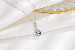 Macro shot of S925 silver necklace with sparkling round zircon in elegant ribbon setting