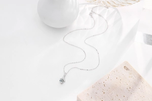 Macro shot of s925 silver pendant necklace with round zircon in four-prong setting