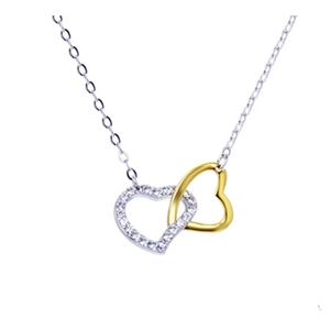 Close-up of interlocking silver cubic zirconia and gold polished heart pendant necklace