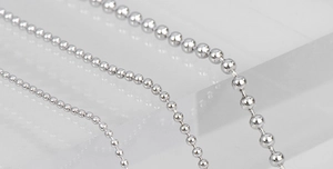 Macro shot of three different diameters of polished S925 sterling silver bead chains