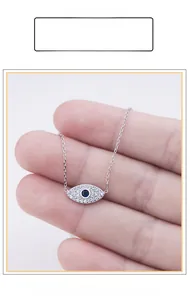Macro view of S925 sterling silver evil eye pendant with blue and white zircon stones