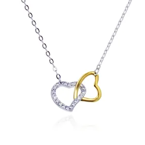 Elegant dual interlocking heart pendant necklace with white zircon pavé on a silver and gold chain