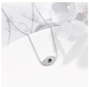 Close-up of S925 silver evil eye pendant necklace with white crystals and black stone