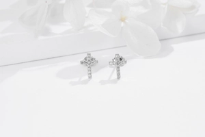 Close-up of S925 sterling silver cross stud earrings with sparkling cubic zirconia stones