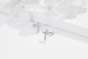 Detailed close-up of S925 sterling silver cross earrings with sparkling cubic zirconia