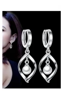 Detail of twisted S925 sterling silver long earrings with dangling white pearls