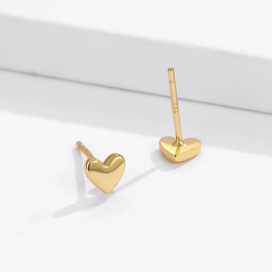 Macro shot of S925 sterling silver stamp on minimalist gold heart stud earrings