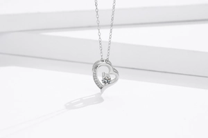 Macro view of S925 sterling silver heart pendant with crystal inlay on geometric background