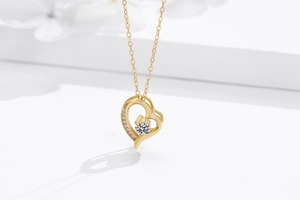 Macro detail of gold-plated 925 silver heart necklace with sparkling zircon crystals