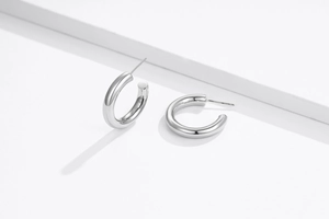 Détail des boucles d'oreilles créoles en argent S925 avec une finition polie miroir