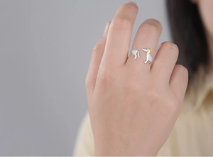 Detail view of adjustable dachshund dog ring with silver and gold two-tone plating