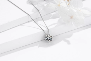 Macro detail of a 925 silver six-prong crown necklace with a brilliant round zircon stone