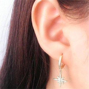 S925 sterling silver gold plated star earrings with pavé zircons worn on ear