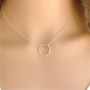 Close-up of minimalist S925 silver necklace with a delicate circle pendant on a model