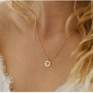Elegant gold S925 silver round pendant necklace with rose engraving on female model