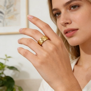 Gold plated stainless steel ring with quilted diamond pattern on female hand