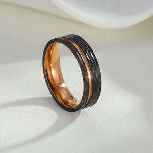 Detail of 6mm dual-tone stainless steel ring with black hammered finish and rose gold groove