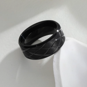Modern black geometric quilted pineapple style ring with matte finish on white pedestal
