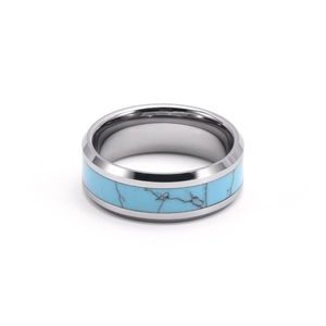 Polished stainless steel ring detail with a turquoise blue inlay and natural texture