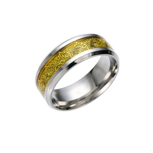 Detail of two-tone steel ring featuring a gold leaf pattern and glitter finish